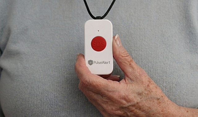 In home medical alert system pendant help button.